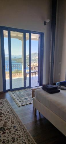 a bedroom with a bed and a view of the ocean at Villa Magiko in Poros