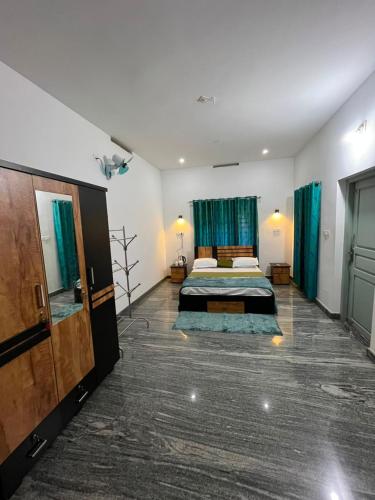 a large room with two beds and a bathroom at Coffee dale in Kalpetta