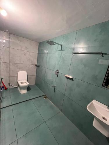 a bathroom with a toilet and a sink at Coffee dale in Kalpetta