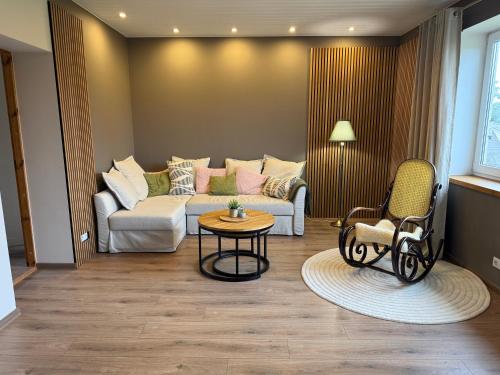 a living room with a couch and a table at Tiigi Apartment Enjoy City Center Stay with Free Bikes and Self Check-in in Kärdla