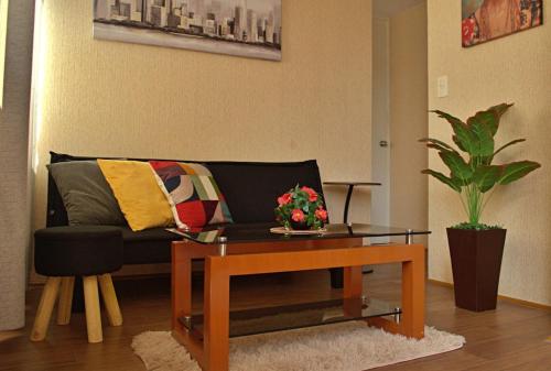 a living room with a couch and a coffee table at Cesar's Apartment - Los Laureles in Lima