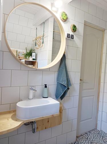 a bathroom with a sink and a mirror at MOHA guesthouse in Szokolya