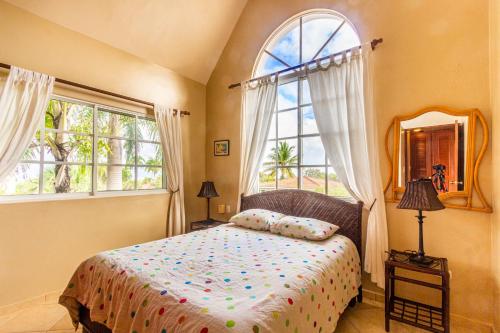 a bedroom with a bed and a large window at Hispaniola Residential - Villas & Apartments! in Sosúa