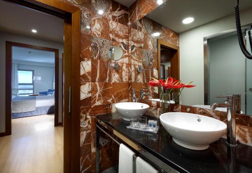 a bathroom with two sinks on a black counter at Villas Eurostars Las Salinas in Caleta De Fuste