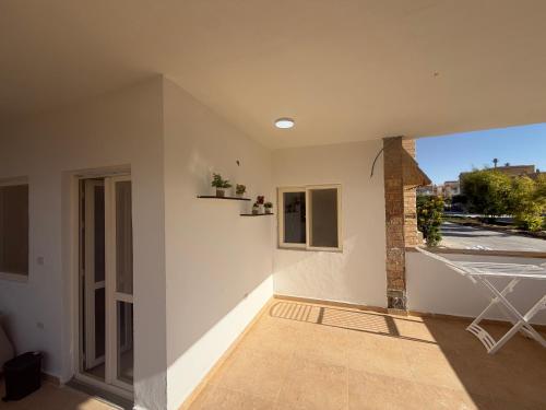 a room with a balcony with a view of a street at Ghazala valley ground floor in El Alamein