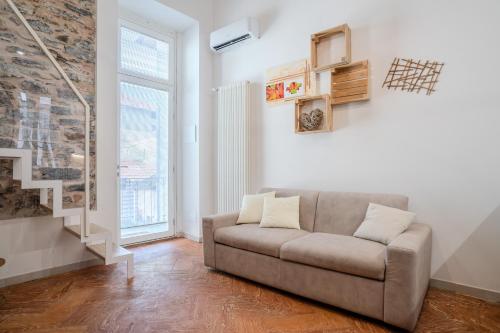 a living room with a couch and a window at Sweet Memories-Gravedona 100m to Lake-Lake Como Escape in Gravedona