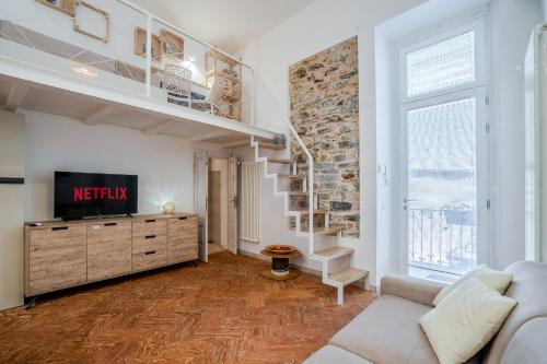 a living room with a couch and a tv at Sweet Memories-Gravedona 100m to Lake-Lake Como Escape in Gravedona
