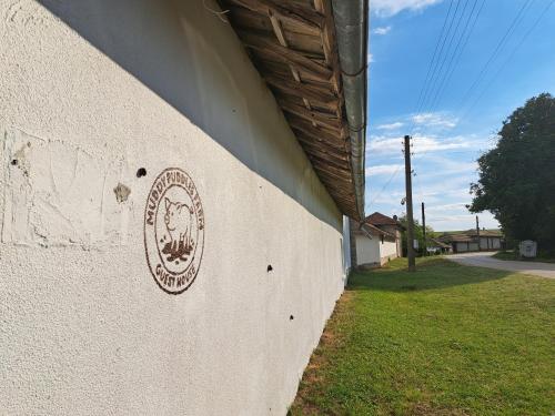 a building with a sign on the side of it at Muddy Puddles Farm in Kovachevets