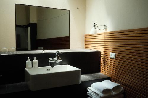 a bathroom with a sink and a large mirror at Hotel la Plaça Madremanya in Madremanya