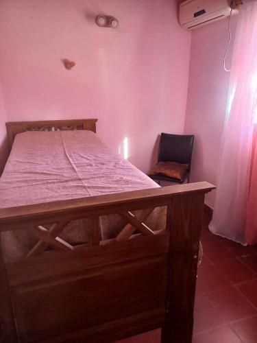 a bed in a room with a table and a chair at Olloqui Dpto in Villa Mercedes
