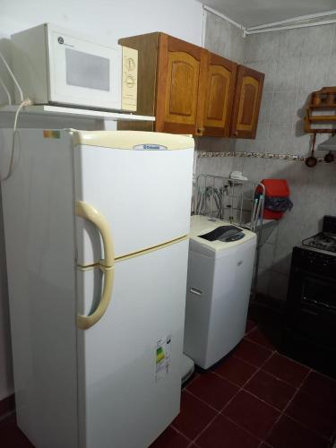 a kitchen with a white refrigerator and a microwave at Olloqui Dpto in Villa Mercedes
