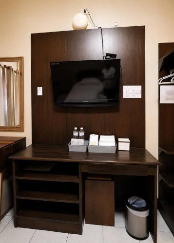 a wooden desk with a tv on a wall at Chomphu Phukha Resort-Mountain View Nan in Pua