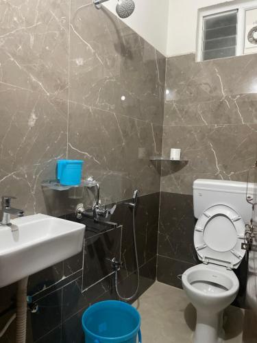a bathroom with a toilet and a sink at Narayana Avenue , kondapur 2 Bhk in Hyderabad