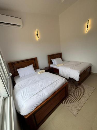 two twin beds in a room with at Coastal Escape Haven in Mchamba Wima