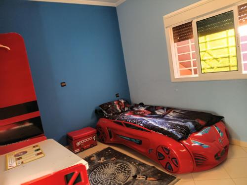 a room with a bed in the corner of a room at house dream in Berkane