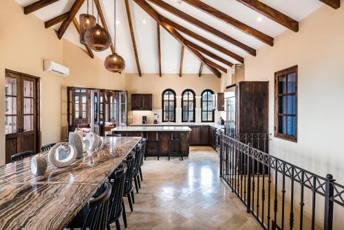 an open kitchen with a long table and chairs at Las Catalinas Doorway in Playa Flamingo