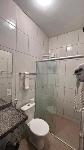 a bathroom with a toilet and a glass shower at Beleleus Jeri in Jericoacoara