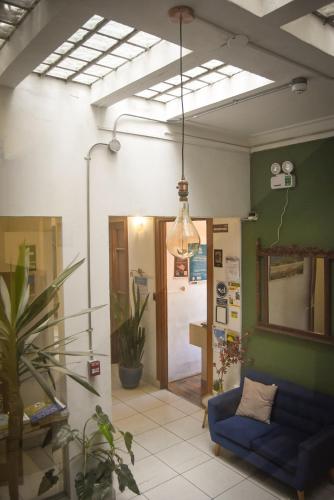 a living room with a blue couch and a light at Maison verte - Guest House in Arequipa