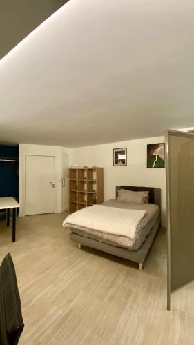 a bedroom with a bed and a desk in a room at Wohnatelier Calw in Calw