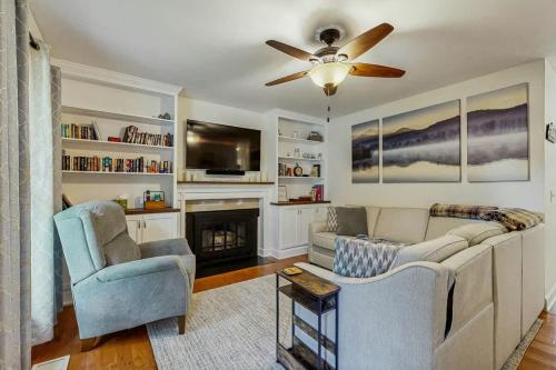 a living room with a couch and a ceiling fan at Rustic Retreat in Franklin