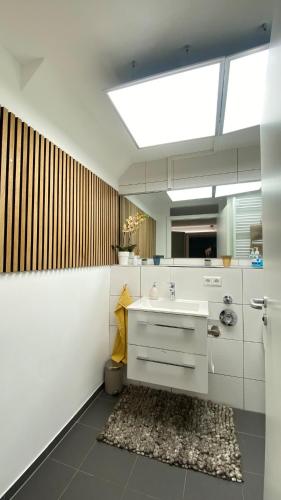 a white bathroom with a sink and a mirror at Wohnatelier Calw in Calw