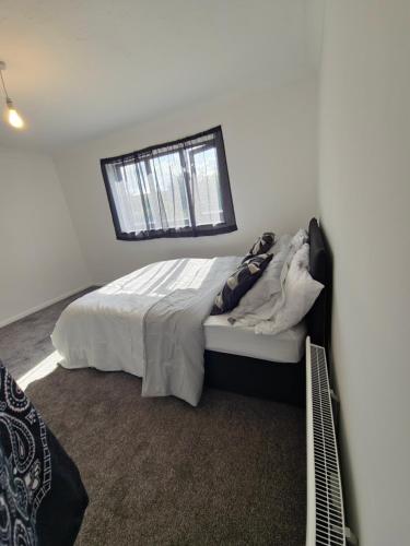 a bedroom with a bed and a window at Chilux in Rainham