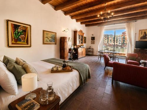 a bedroom with a large bed and a living room at Bosa Exclusive Apartments "Bosa Apartments" in Bosa