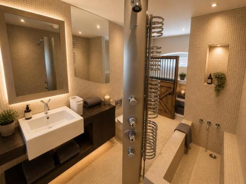 a bathroom with a sink and a shower at The Stalls Suite at Strattons in Swaffham