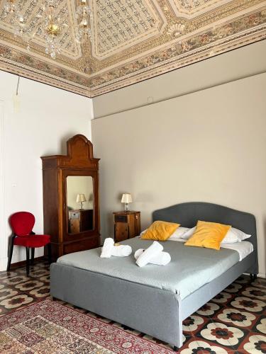 a bedroom with a bed with a coffered ceiling at DS Apartment in Catania