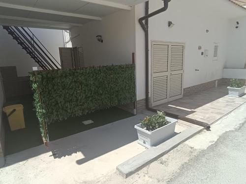 a room with two plants on the side of a building at Costa Marina in Marsala