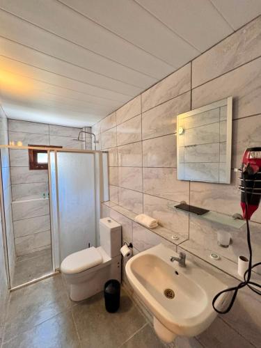 a bathroom with a white sink and a toilet at Petrinos Butik Otel in Datca
