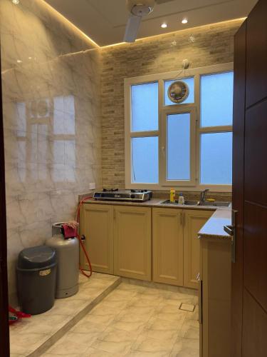 a kitchen being remodeled with a sink and a window at بنايه بيت الشب in Ţāqah