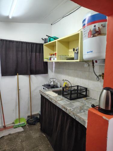 a kitchen with a counter top in a room at La casita de José in Villa Unión