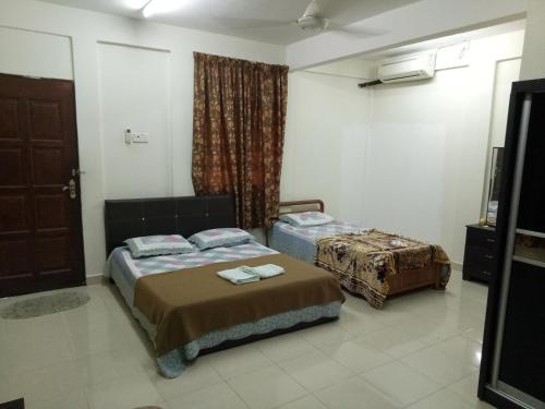 Cama ou camas em um quarto em Saba Lodge Dungun
