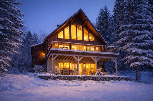 a log cabin in the snow at night at The Bellows House - Views Deck Skiing in Fleischmanns