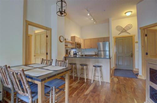 a kitchen and dining room with a table and chairs at CS407 Copper Springs in Copper Mountain