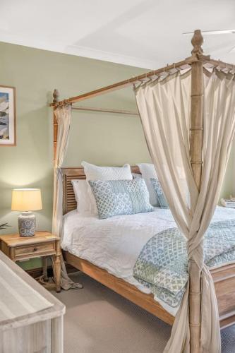 a bedroom with a bed with a canopy at Three Acres, Barossa Valley in Williamstown