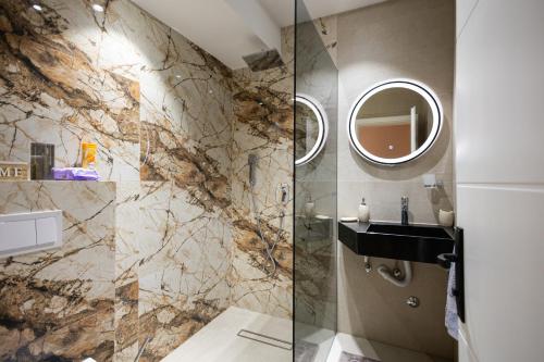 a bathroom with a sink and a shower at Villa Eterna in Tarčin