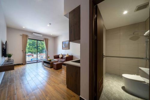 a living room with a couch and a sink in a bathroom at catba new city hotel in Cat Ba