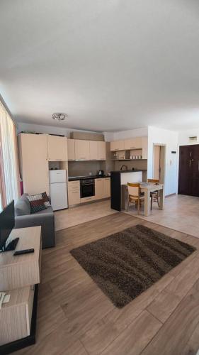 a living room with a couch and a table at Студио JASMIN in Tsarevo
