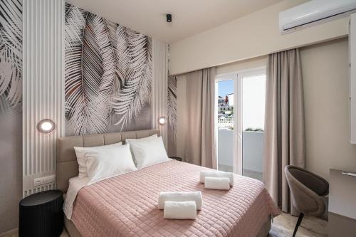 a bedroom with a bed with a pink blanket at Agathe Apartment in Ierapetra