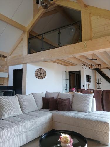 a living room with a couch and a table at Gîte Chalet Bellevue in Couvin