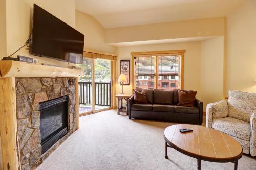 a living room with a fireplace and a tv at CS425 Copper Springs in Copper Mountain