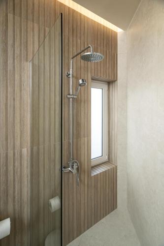 a shower with a glass door in a bathroom at Agathe Apartment in Ierapetra