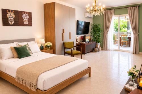 a bedroom with a large bed and a living room at Flavia's House in Gaggi