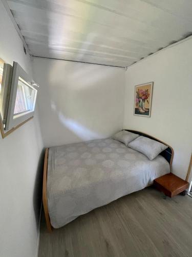 a bedroom with a bed and a window in it at Maison familiale in Froid-Chapelle