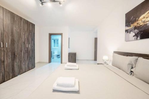 a large white room with two white mats on the floor at Sandy Soul in Birżebbuġa