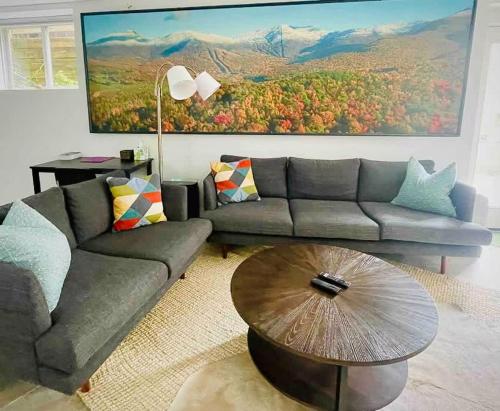 a living room with a couch and a table at The Bunker - Ski Shuttle Shopping Center in Stowe