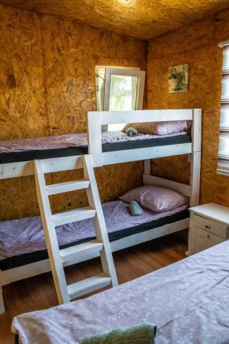 a room with two bunk beds and a mirror at Lakeside Cabin in Jablanica