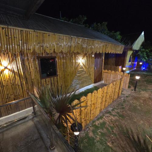 a wooden house with a fence and lights on it at Rajashree Multipurpose Resort in Solapur
